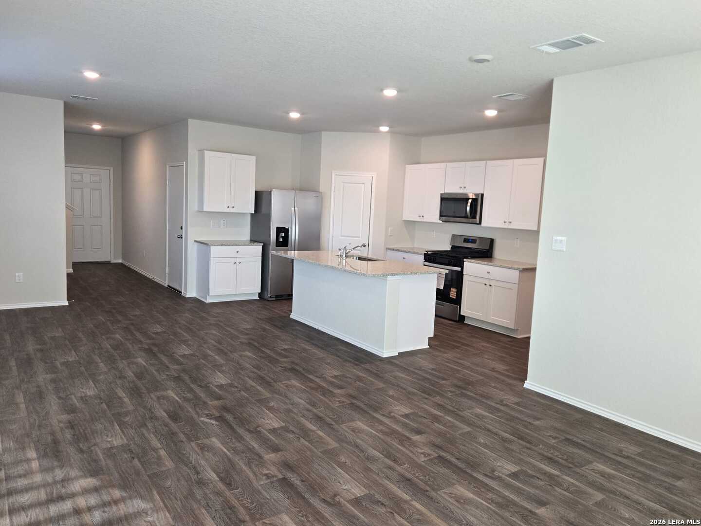 14674 Clay Rdg Run San Antonio, TX 78253 - Photo 7 of 14 a view of kitchen with microwave a refrigerator and a sink