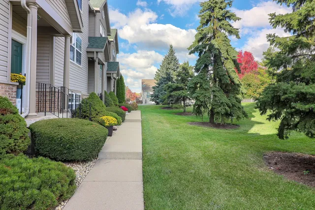 a flower garden is sitting in front of a house