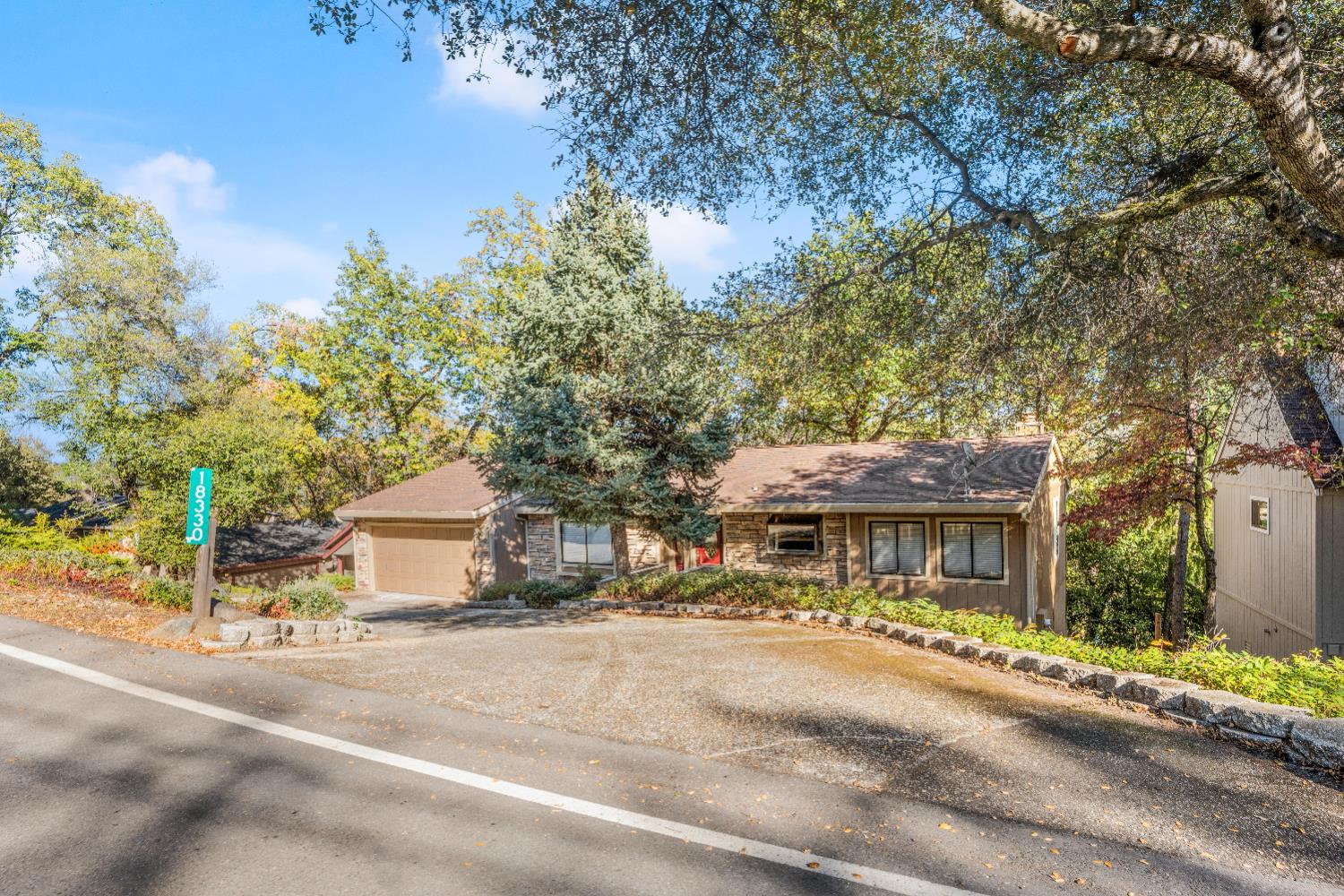 18330 Hummingbird Drive Penn Valley, CA 95946 - Photo 59 of 62 a front view of a house with a yard and a garage