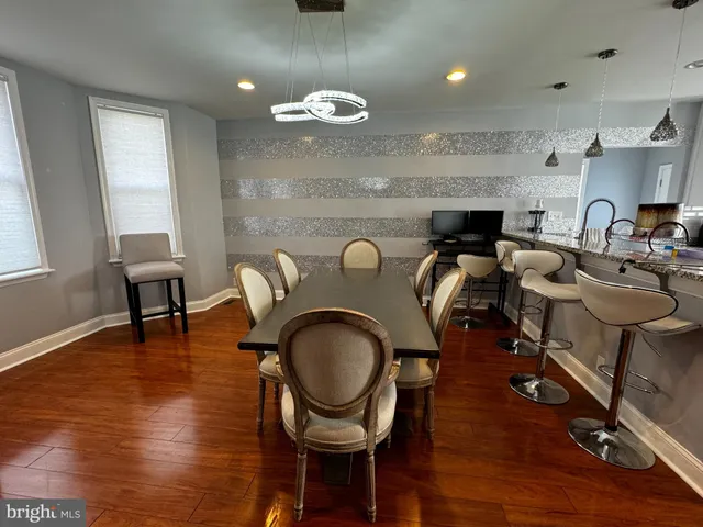 a living room with furniture a mirror and a dining table