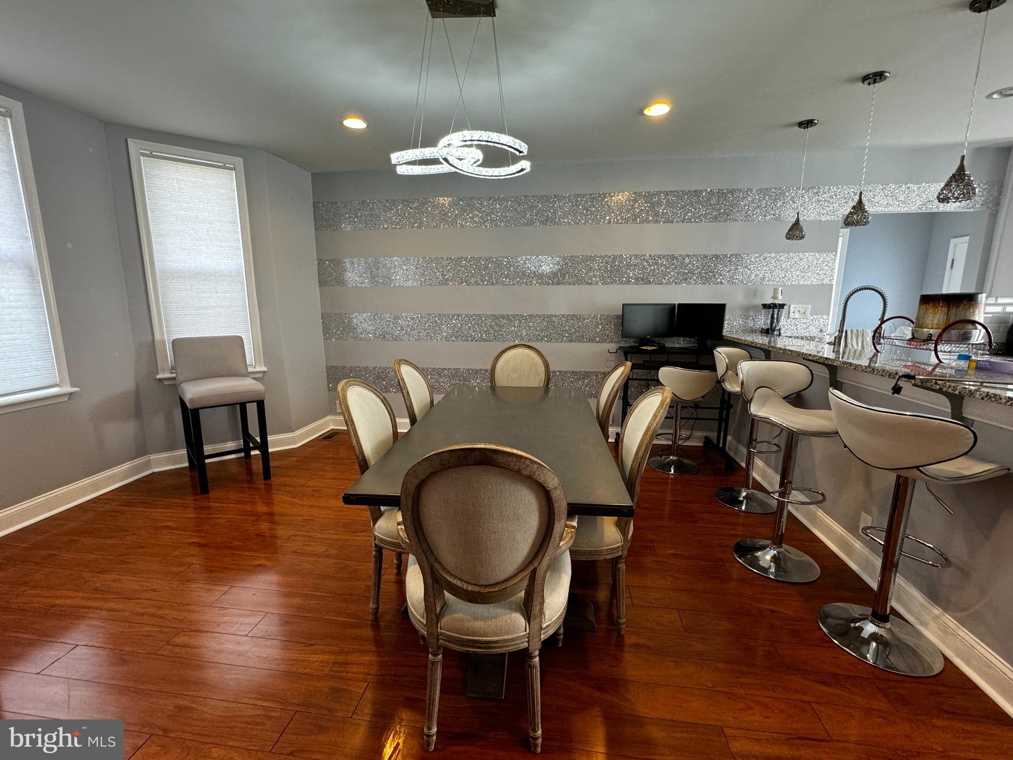 a living room with furniture a mirror and a dining table