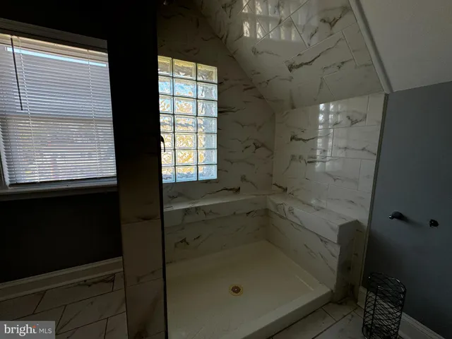 a bathroom with a shower sink and mirror
