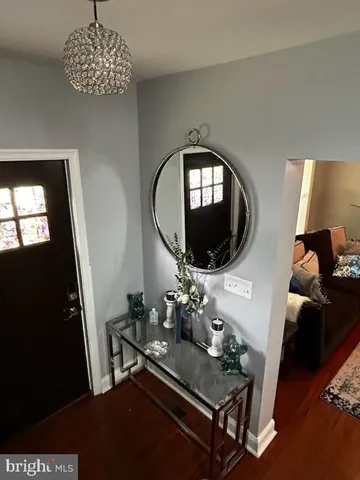 a living room with furniture and a mirror