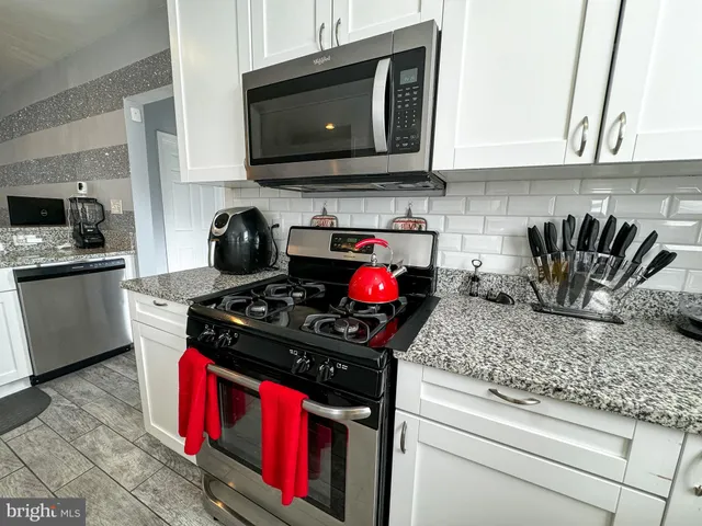 a kitchen with a stove and a microwave