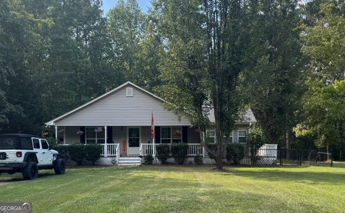 211 Sunfish Trail Southwest Eatonton, GA 31024 - Photo 1 of 40 a front view of a house with a garden and trees