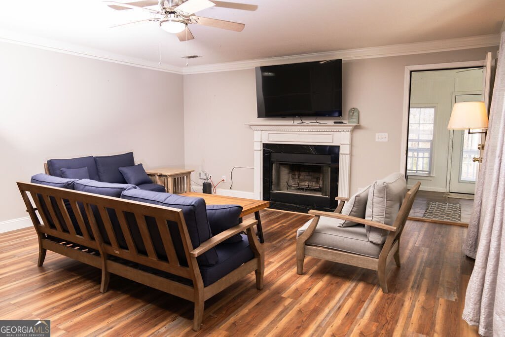 211 Sunfish Trail Southwest Eatonton, GA 31024 - Photo 2 of 40 a living room with furniture a flat screen tv and a fireplace
