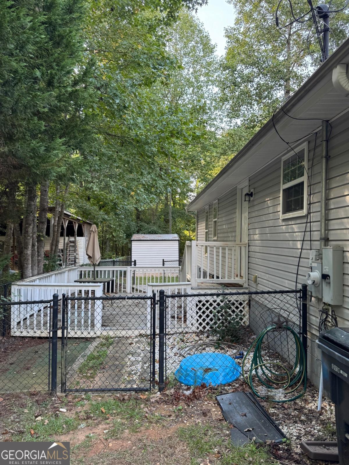 211 Sunfish Trail Southwest Eatonton, GA 31024 - Photo 35 of 40 a backyard of a house with wooden fence and large trees