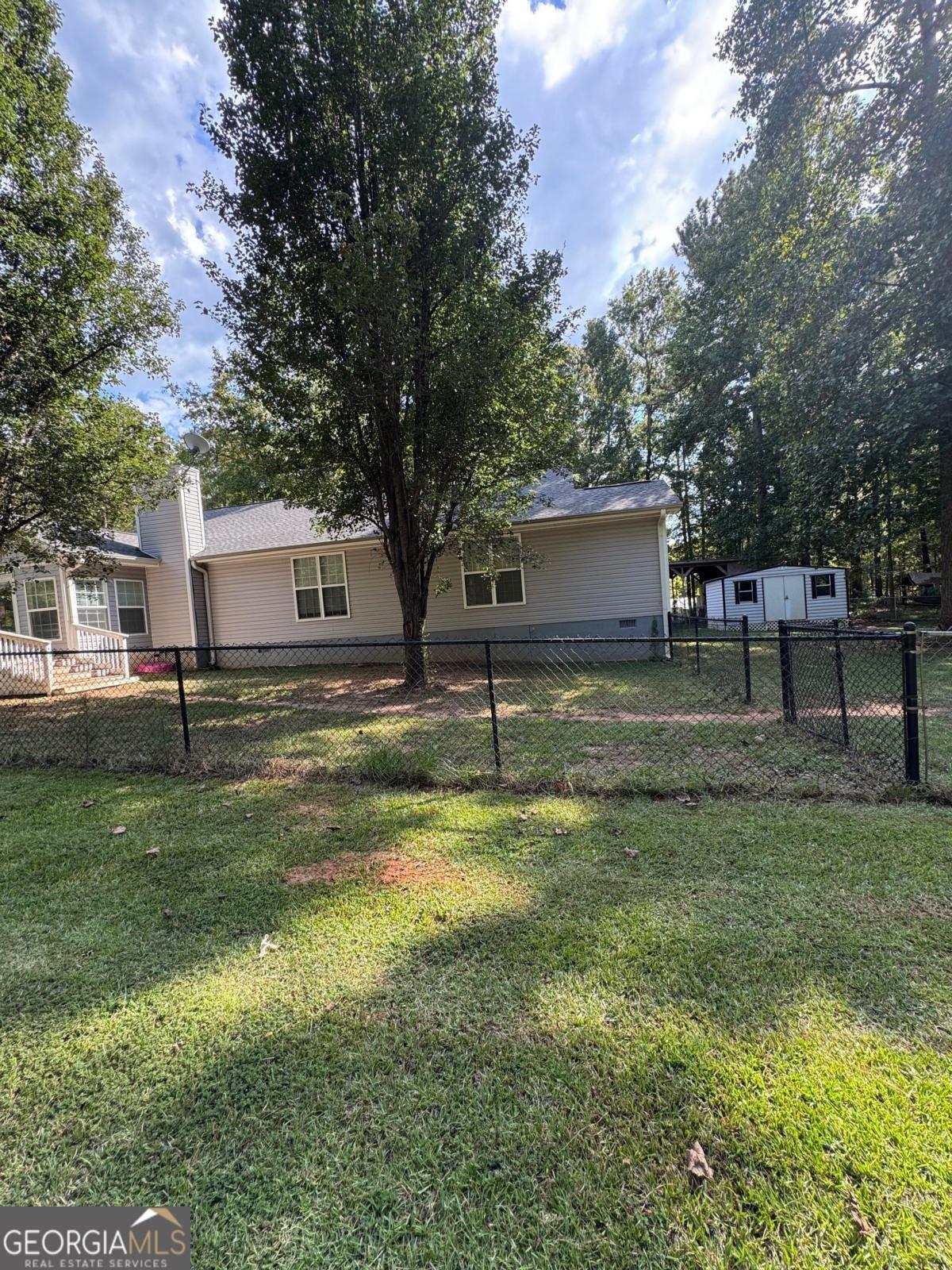 211 Sunfish Trail Southwest Eatonton, GA 31024 - Photo 36 of 40 a view of a house with a yard