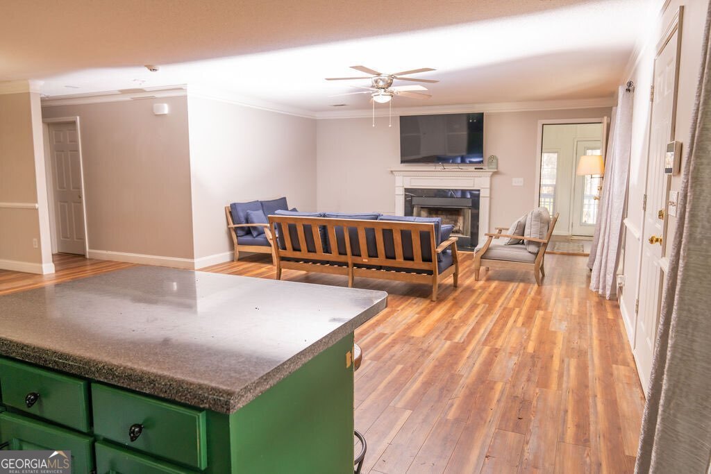 211 Sunfish Trail Southwest Eatonton, GA 31024 - Photo 5 of 40 a living room with furniture a flat screen tv and a fireplace