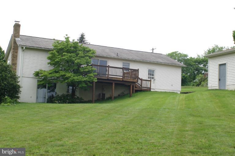 8422 Edgewood Church Road Frederick, MD 21702 - Photo 1 of 17 a view of a backyard with plants and large tree