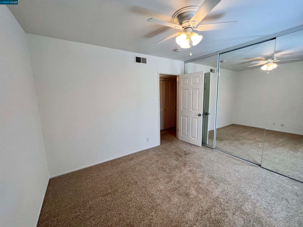 2060 Camel Lane Walnut Creek, CA 94596 - Photo 13 of 33 an empty room with closet and a ceiling fan