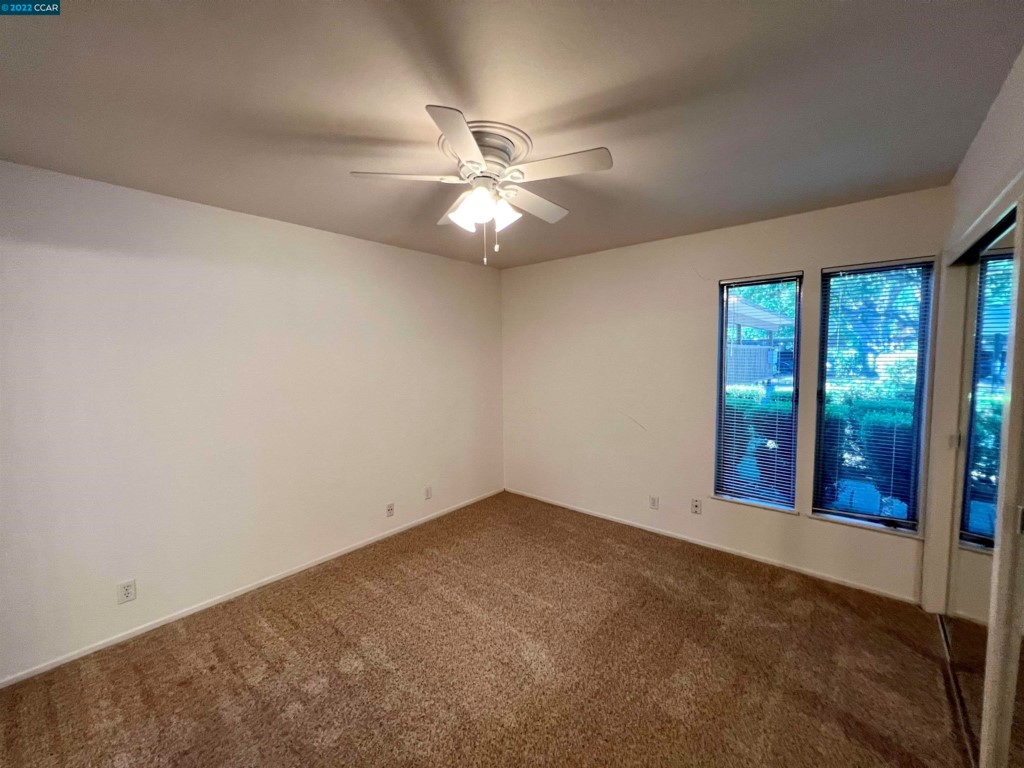 2060 Camel Lane Walnut Creek, CA 94596 - Photo 19 of 33 an empty room with windows and fan