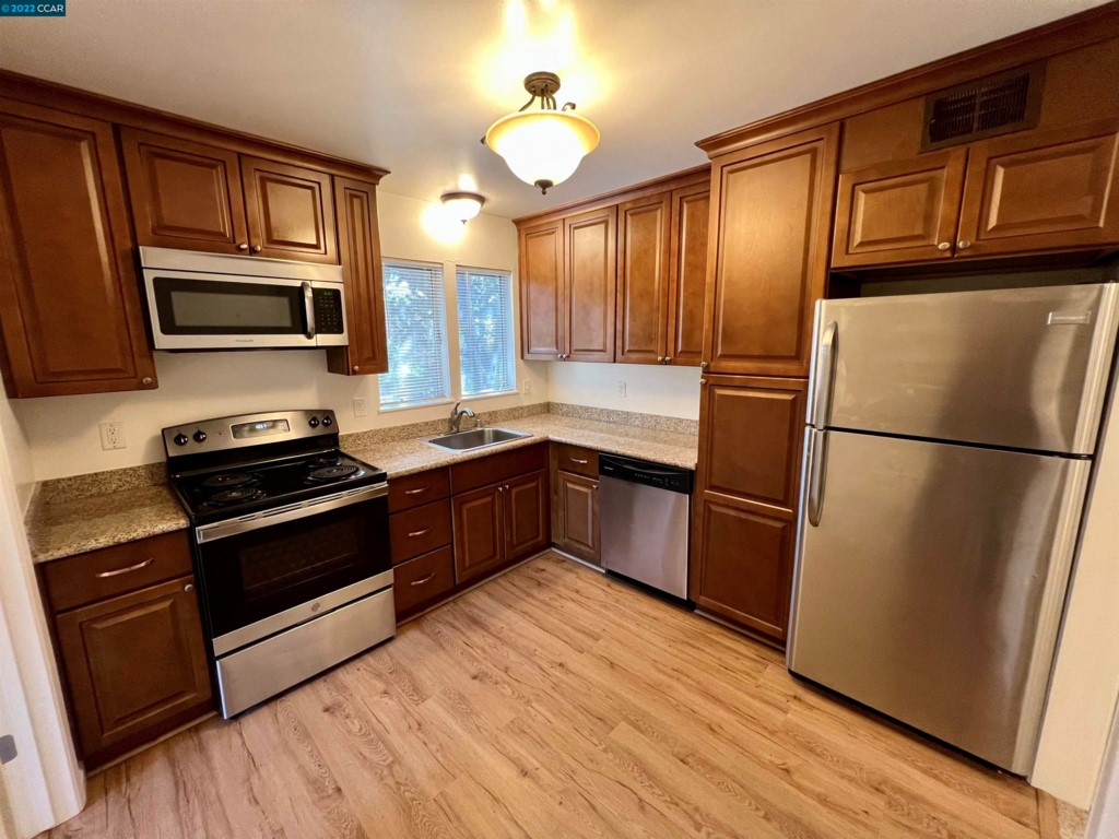 2060 Camel Lane Walnut Creek, CA 94596 - Photo 8 of 33 a kitchen with a refrigerator stove top oven and sink