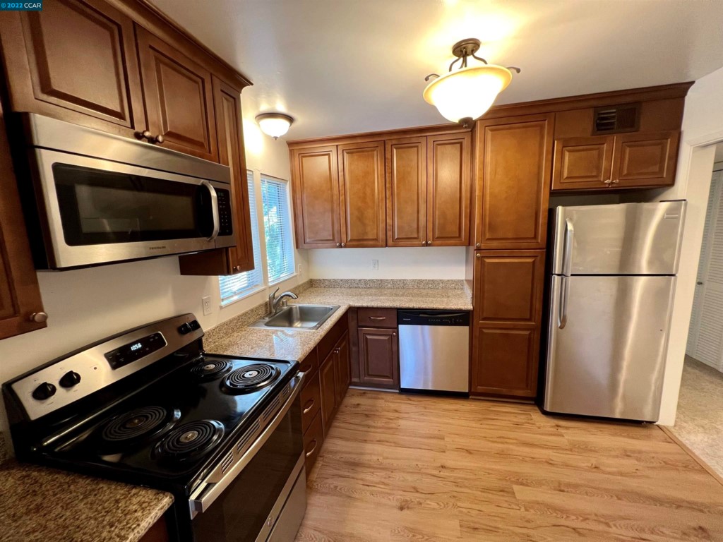 2060 Camel Lane Walnut Creek, CA 94596 - Photo 9 of 33 a kitchen with a refrigerator stove and microwave