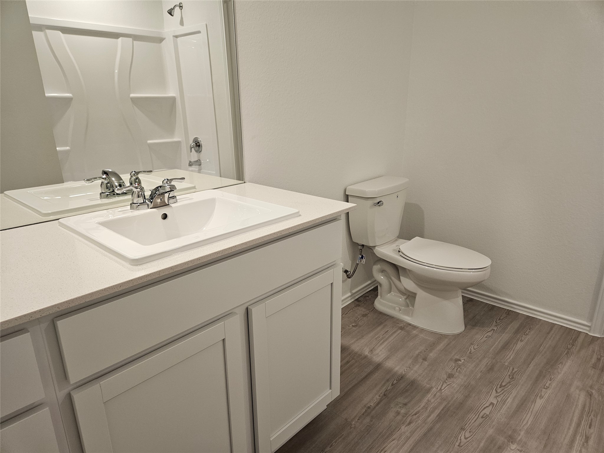 23604 Tiny Moons Way Elgin, TX 78621 - Photo 11 of 25 Bathroom featuring toilet, vanity, baseboards, and wood finished floors