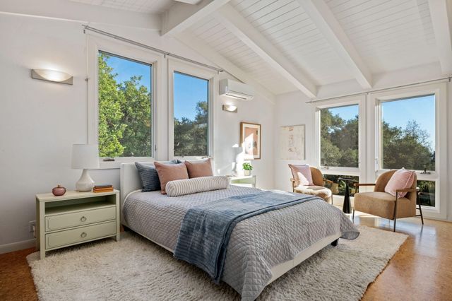a bathroom with a granite countertop sink a toilet a mirror and shower