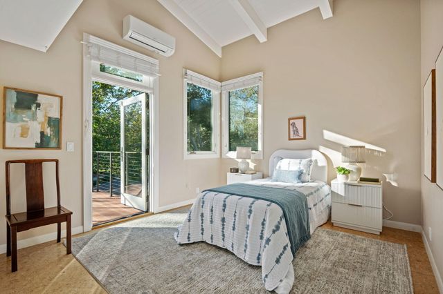 an outdoor sitting area with furniture and umbrella
