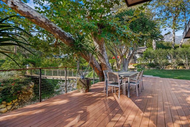 a view of a backyard with plants and lake view