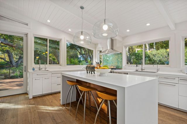 a kitchen with center island and windows