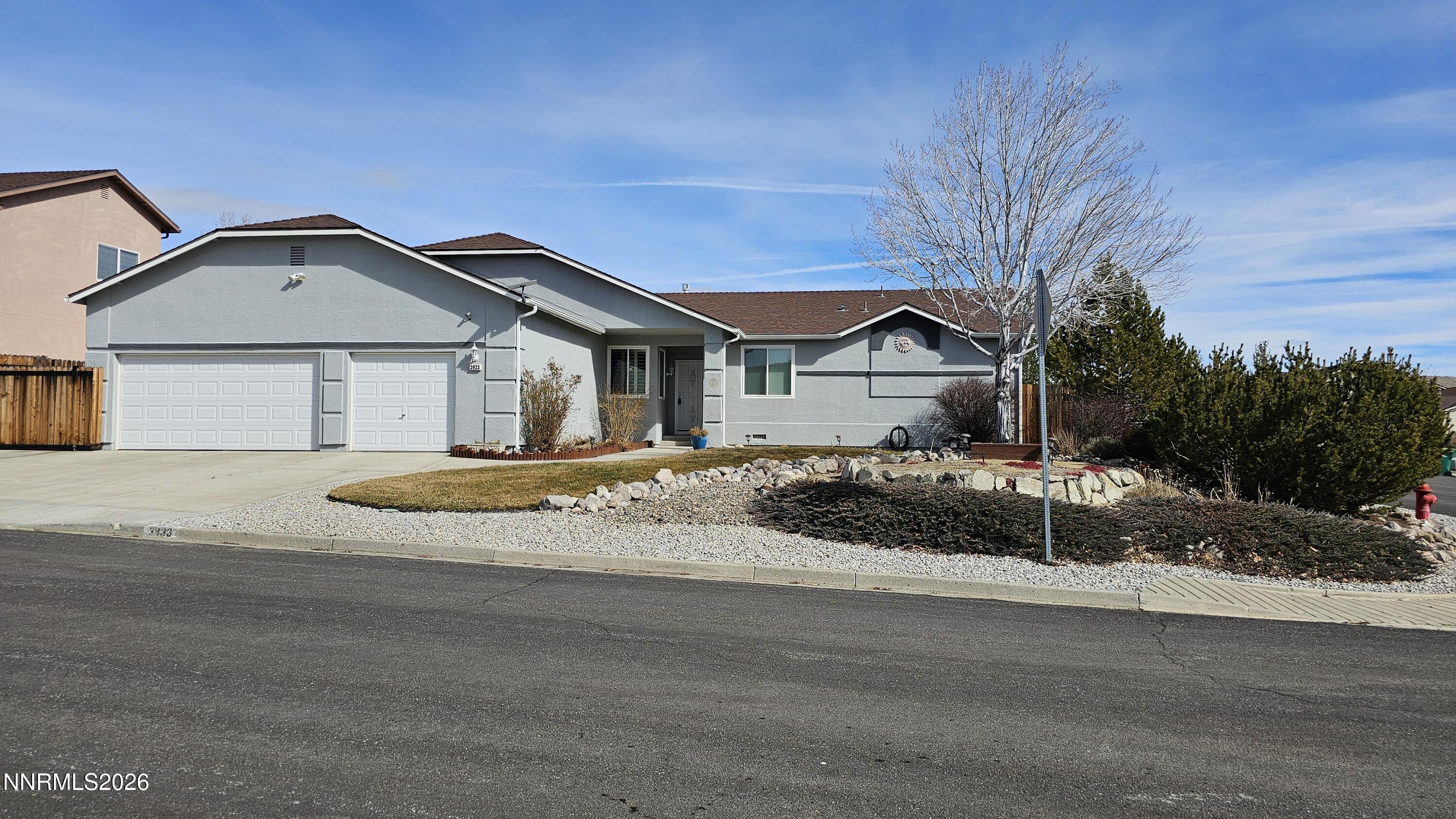 3933 Border Court Reno, NV 89508 - Photo 1 of 36 a front view of a house with a yard and garage