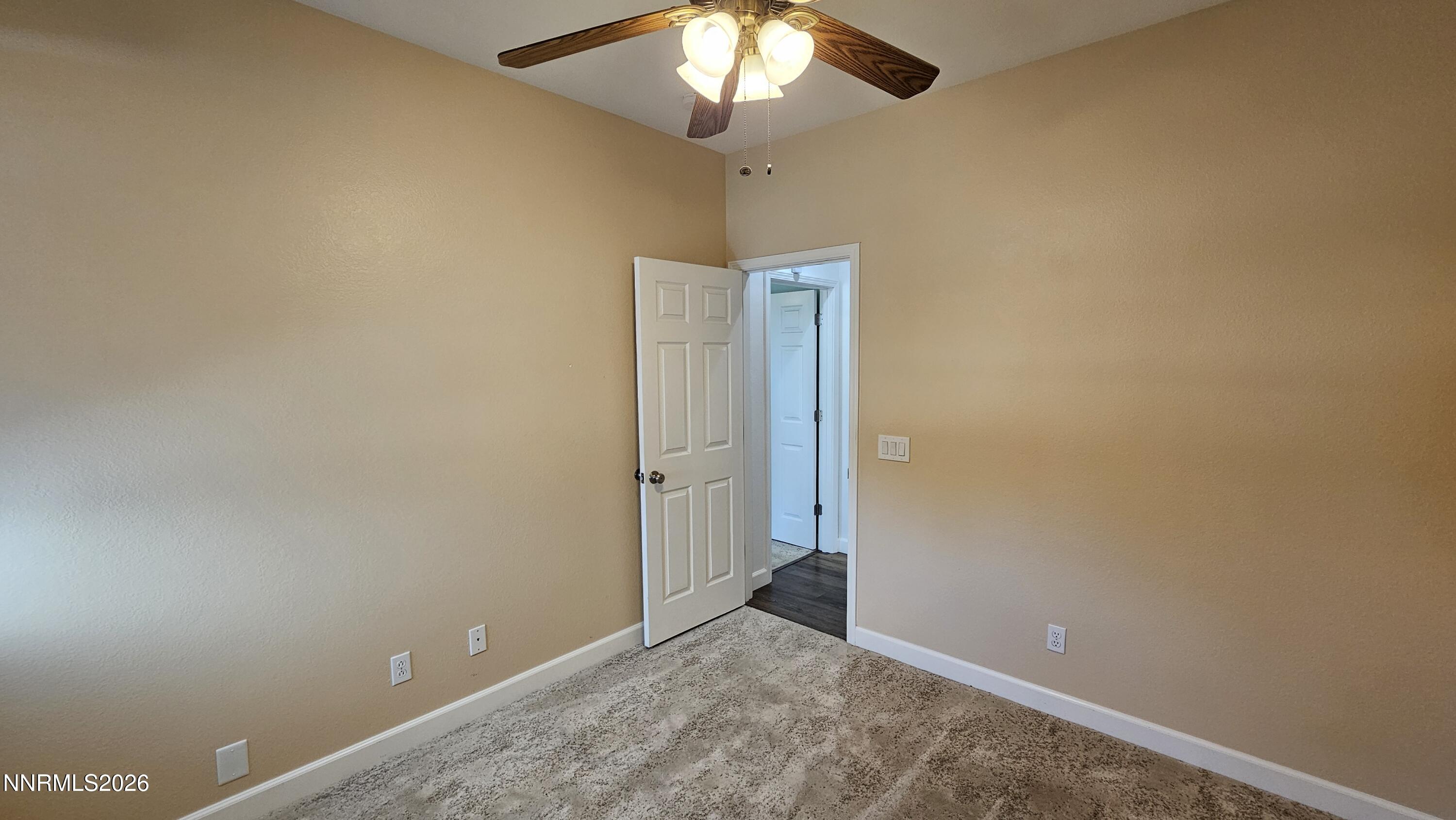 3933 Border Court Reno, NV 89508 - Photo 18 of 36 an empty room with a chandelier fan and closet