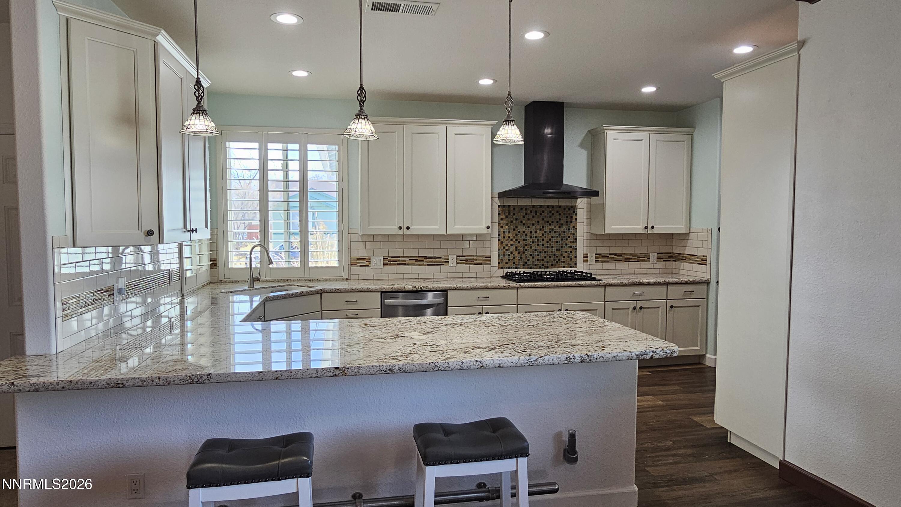 3933 Border Court Reno, NV 89508 - Photo 3 of 36 a kitchen with kitchen island granite countertop a stove a sink and a refrigerator