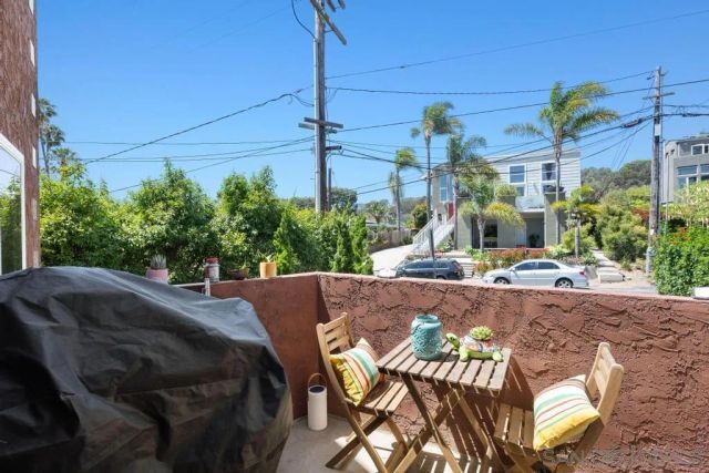 a view of a patio with table and chairs potted plants