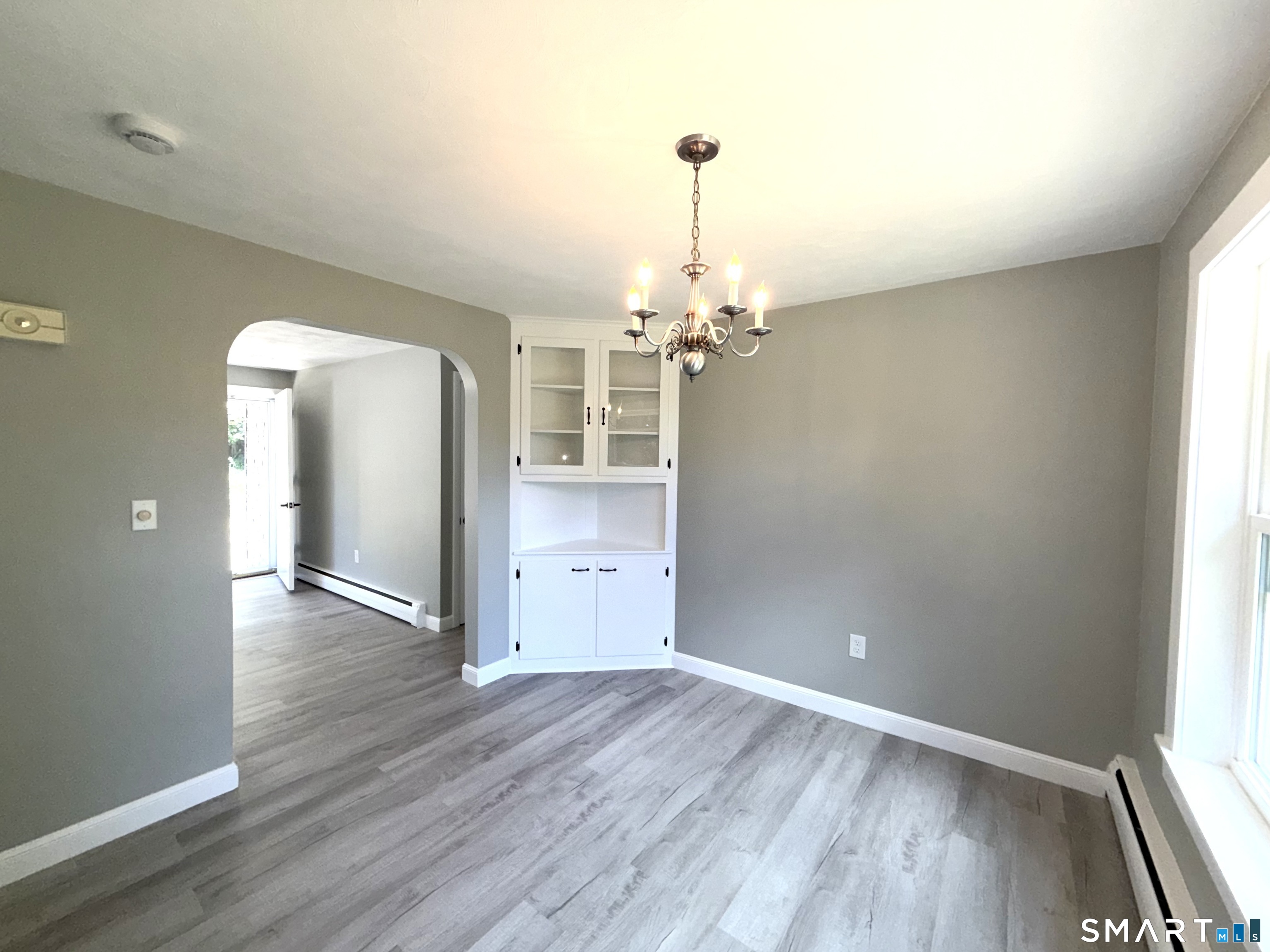 341 Harland Road Norwich, CT 06360 - Photo 8 of 29 wooden floor in an empty room with a window