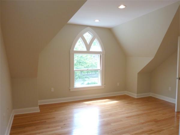 447 Washington Street, Unit 3 Brookline, MA 02446 - Photo 11 of 20 an empty room with wooden floor and windows