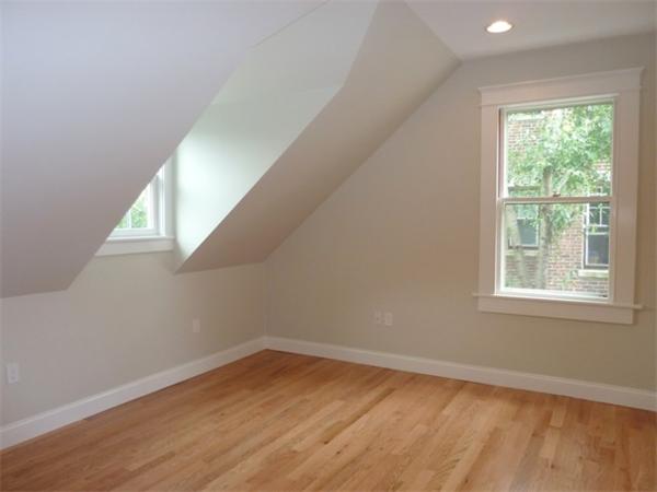 447 Washington Street, Unit 3 Brookline, MA 02446 - Photo 14 of 20 an empty room with wooden floor and windows