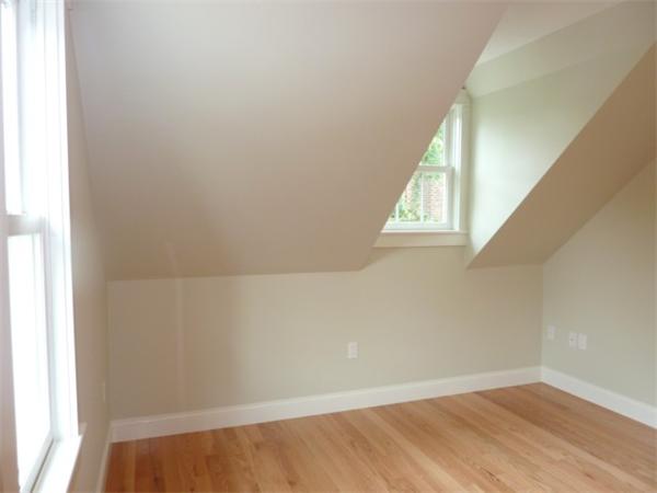 447 Washington Street, Unit 3 Brookline, MA 02446 - Photo 17 of 20 an empty room with wooden floor and windows