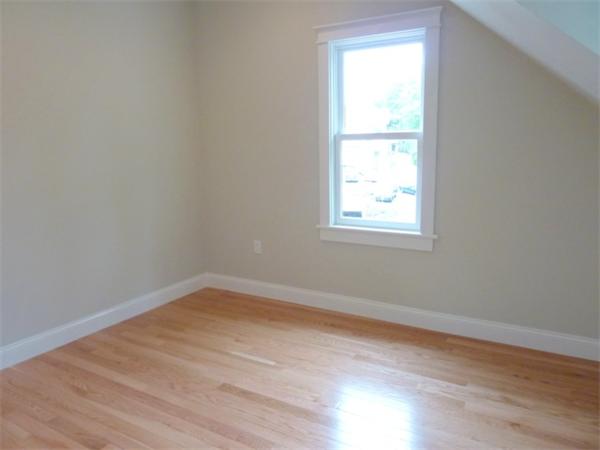 447 Washington Street, Unit 3 Brookline, MA 02446 - Photo 18 of 20 an empty room with wooden floor and a window