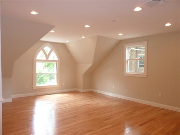 447 Washington Street, Unit 3 Brookline, MA 02446 - Photo 4 of 20 an empty room with wooden floor and windows
