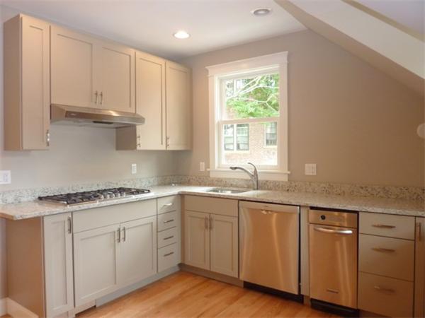 447 Washington Street, Unit 3 Brookline, MA 02446 - Photo 7 of 20 a kitchen with granite countertop white cabinets and white appliances