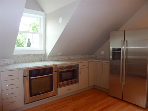 447 Washington Street, Unit 3 Brookline, MA 02446 - Photo 8 of 20 a kitchen with a stove and a microwave