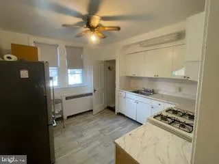 a kitchen that has a lot of cabinets in it and stainless steel appliances
