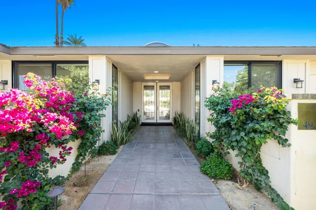 a front view of a house having fountain
