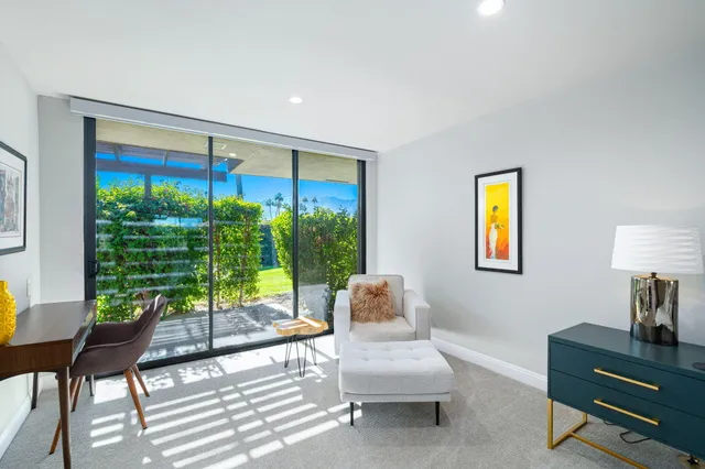 a spacious bedroom with a bed and wooden floor