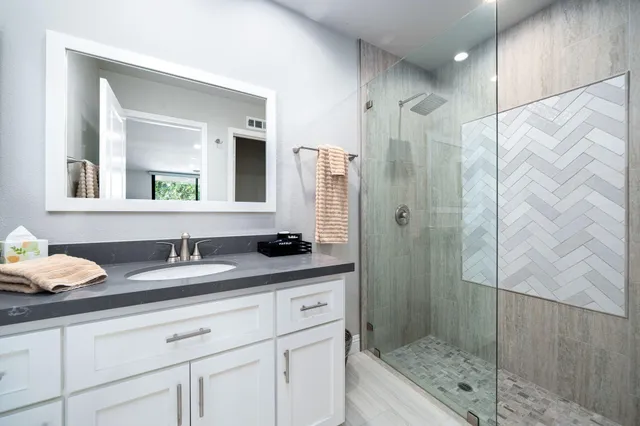 a view of a house with a yard and potted plants