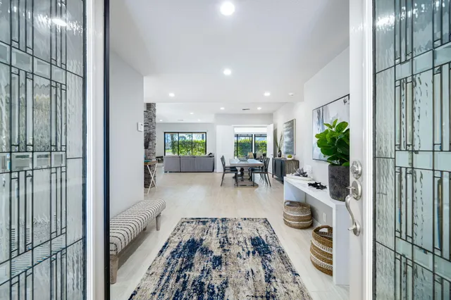 a living room with furniture and a floor to ceiling window