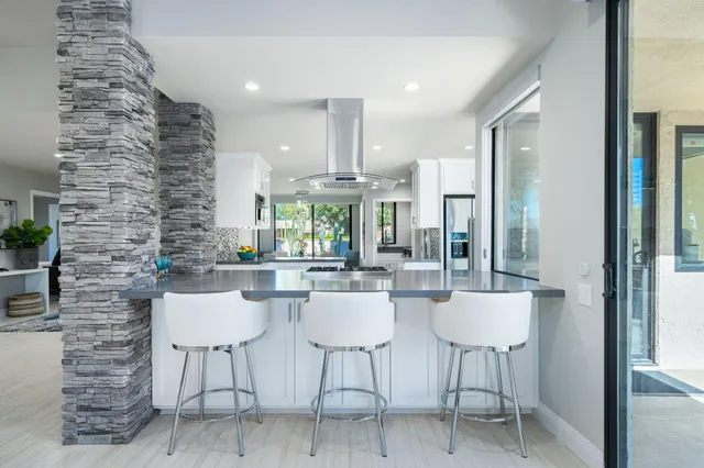 a dining room with furniture and a potted plant