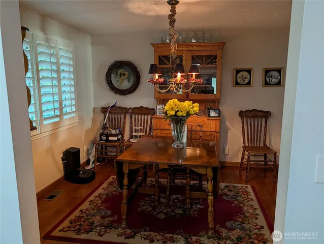 a living room with furniture a flat screen tv and a floor to ceiling window