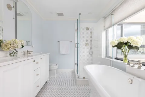 a white bath tub sitting next to a white sink