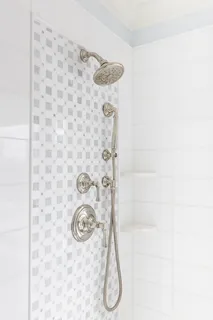 a bedroom with a bed chair and a large window