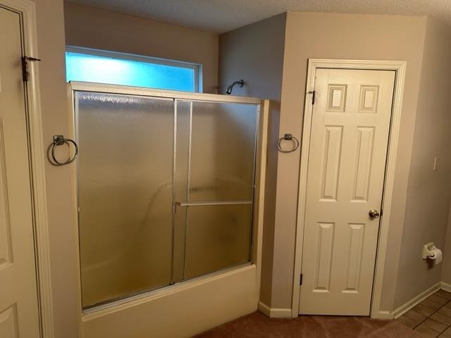 7764 Reese Road Memphis, TN 38133 - Photo 11 of 12 a bathroom with a glass shower door