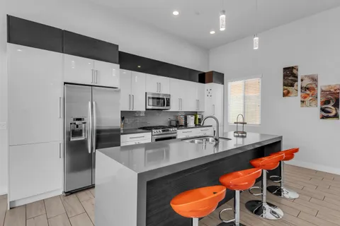 a kitchen with a sink cabinets and wooden floor