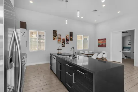 a kitchen with stainless steel appliances granite countertop a refrigerator and a stove