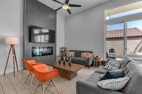 a living room with fireplace furniture and a flat screen tv