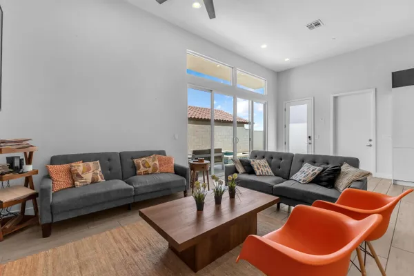 a living room with furniture kitchen and a table