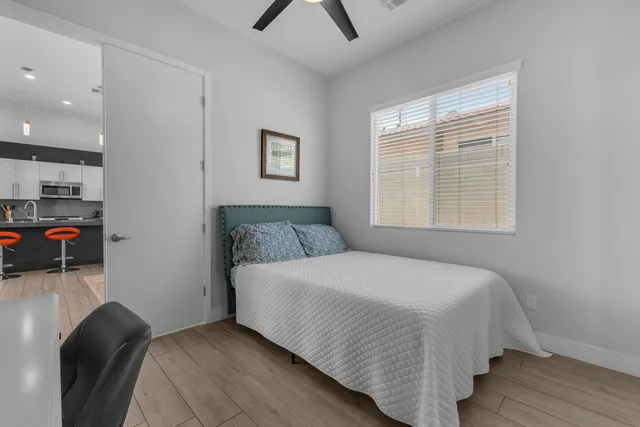 a bedroom with bed and a large mirror